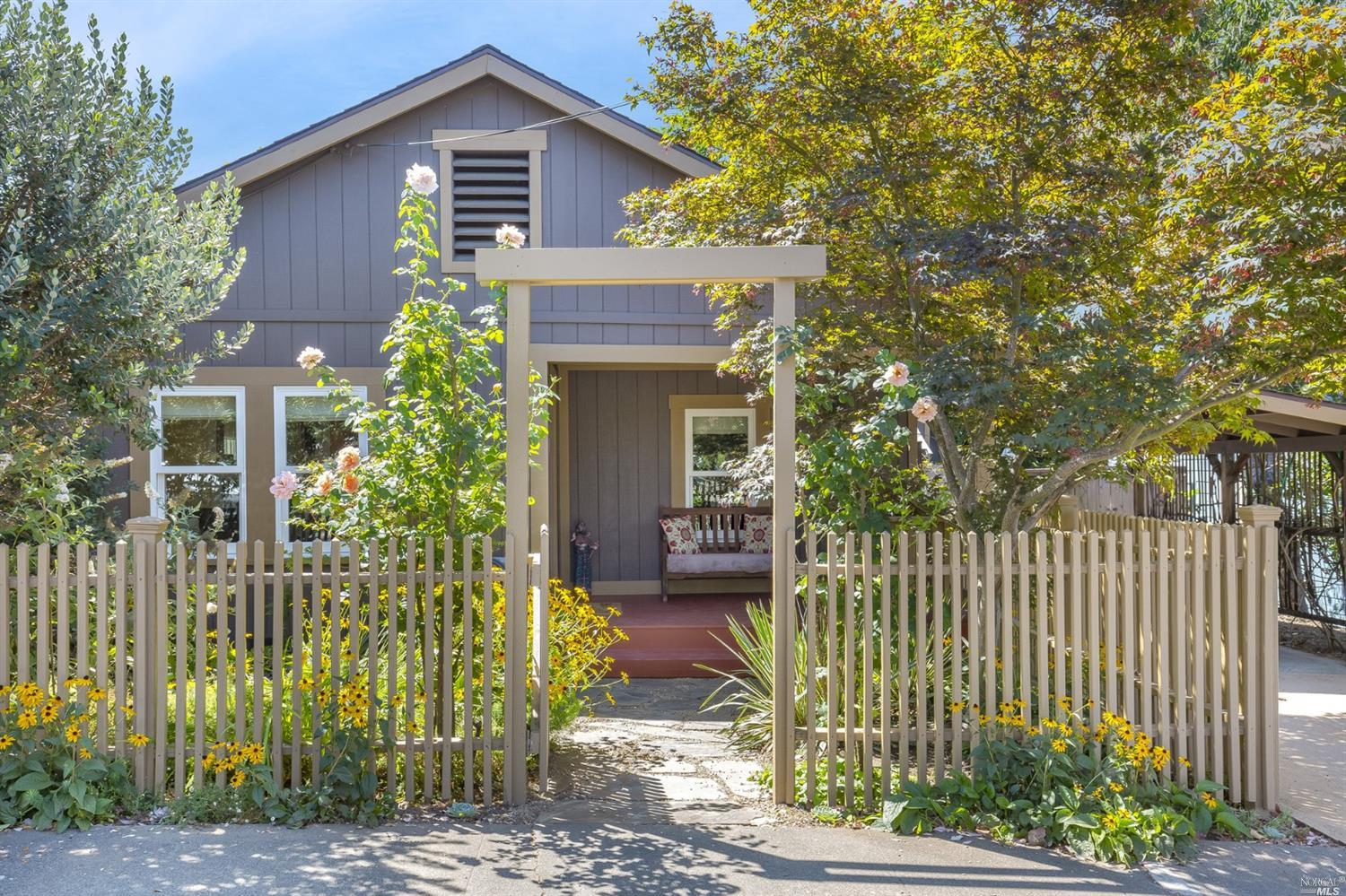 a front view of a house with a garden