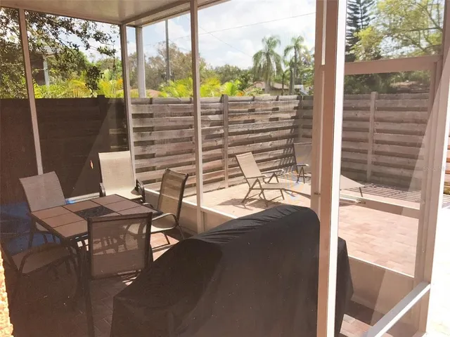 a view of a balcony dining table and chairs