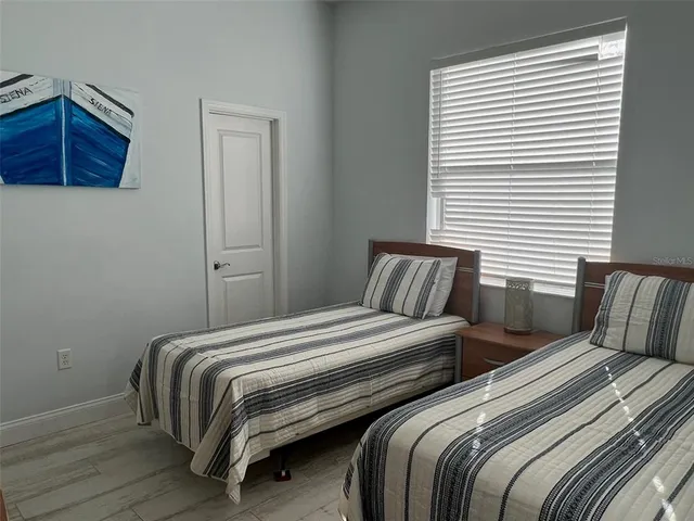 a bedroom with two beds and a dresser