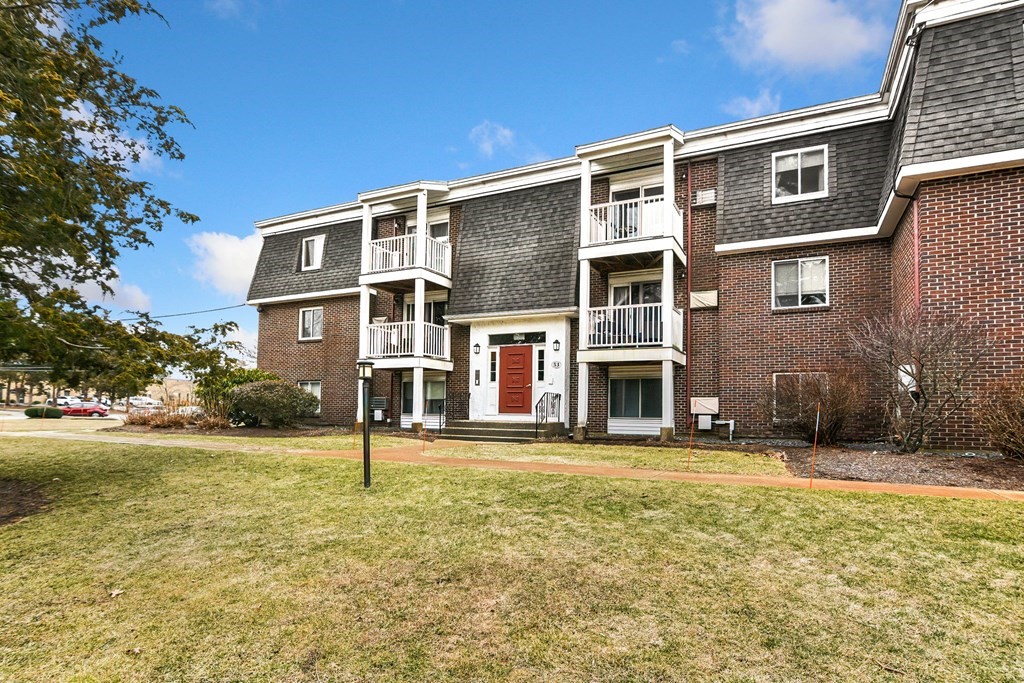 53 Will Drive, Unit 140 Canton, MA 02021 - Photo 1 of 22 a front view of a house with a yard