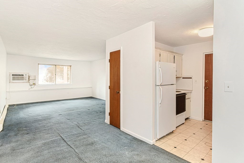 53 Will Drive, Unit 140 Canton, MA 02021 - Photo 11 of 22 a view of a kitchen with refrigerator and cabinet