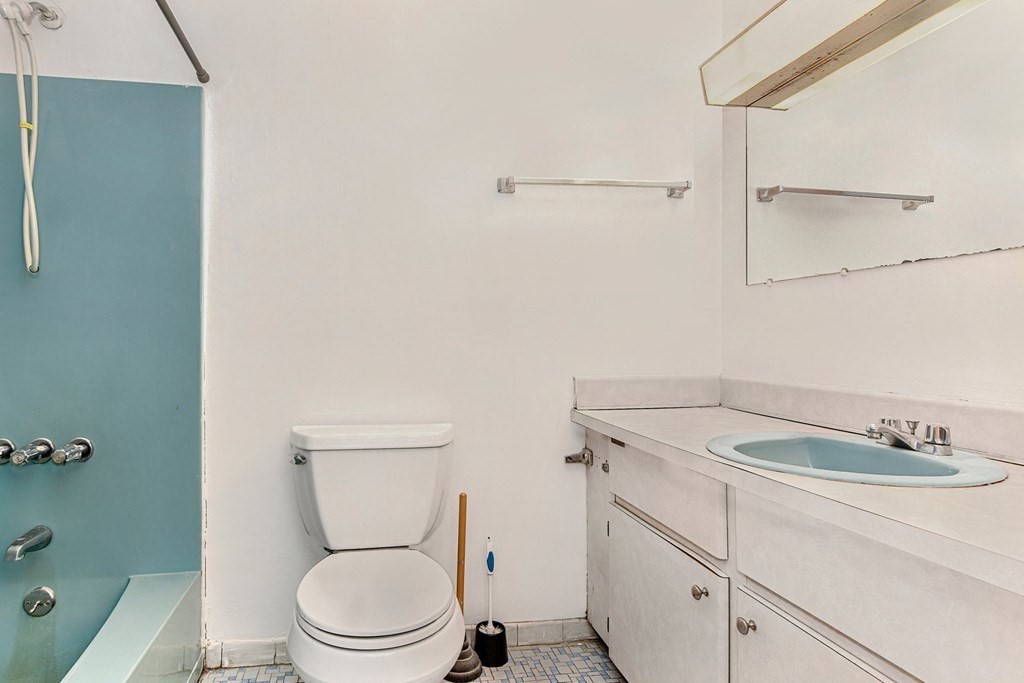 53 Will Drive, Unit 140 Canton, MA 02021 - Photo 13 of 22 a bathroom with a granite countertop toilet sink and mirror