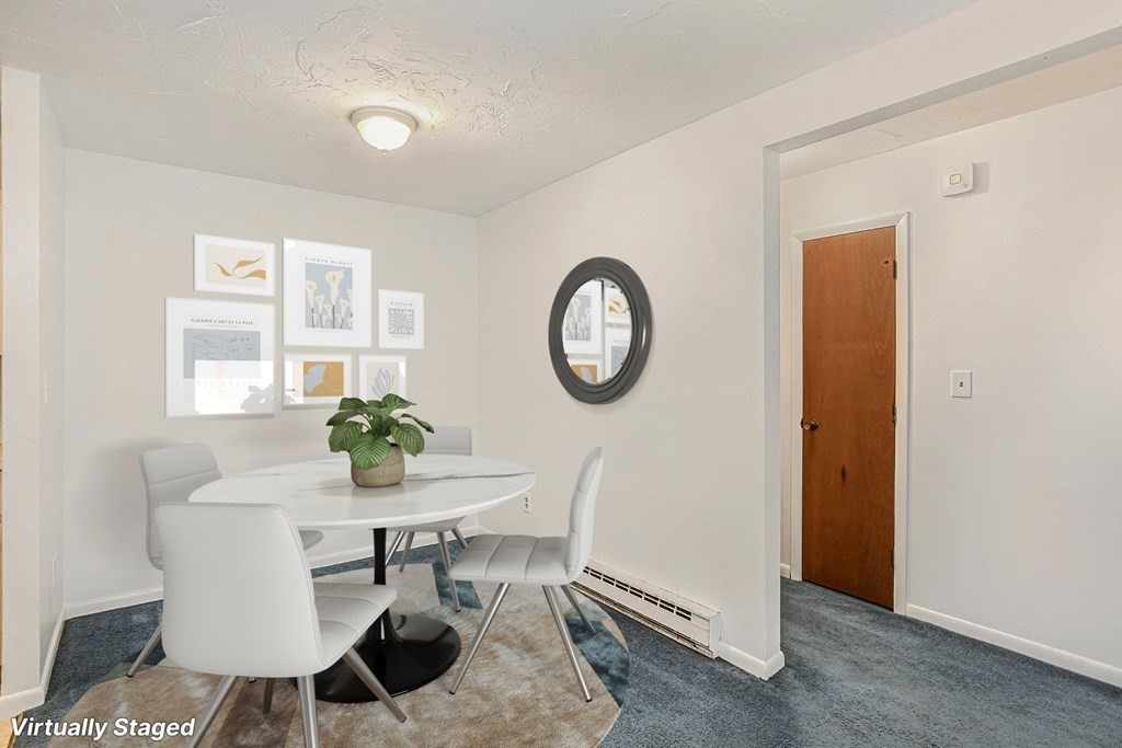 53 Will Drive, Unit 140 Canton, MA 02021 - Photo 3 of 22 a view of a room that has a table and a chair