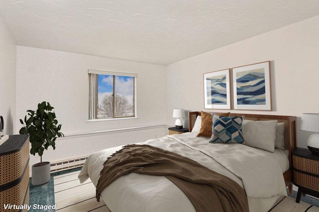 53 Will Drive, Unit 140 Canton, MA 02021 - Photo 5 of 22 a bedroom with a bed and a painting on the wall
