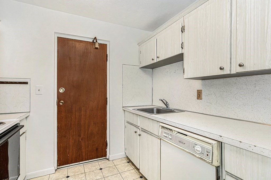53 Will Drive, Unit 140 Canton, MA 02021 - Photo 7 of 22 a kitchen with stainless steel appliances granite countertop a sink and a refrigerator