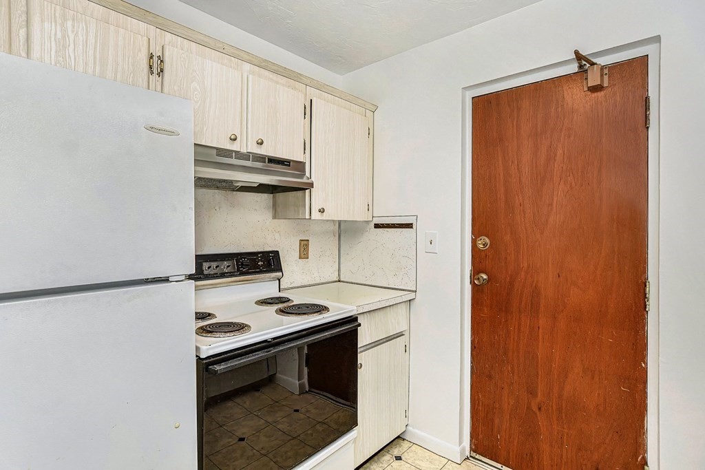 53 Will Drive, Unit 140 Canton, MA 02021 - Photo 8 of 22 a kitchen with stainless steel appliances a stove and a refrigerator