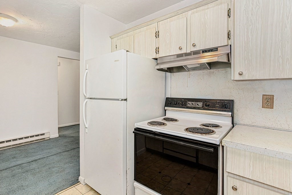 53 Will Drive, Unit 140 Canton, MA 02021 - Photo 9 of 22 a kitchen with cabinets and appliances