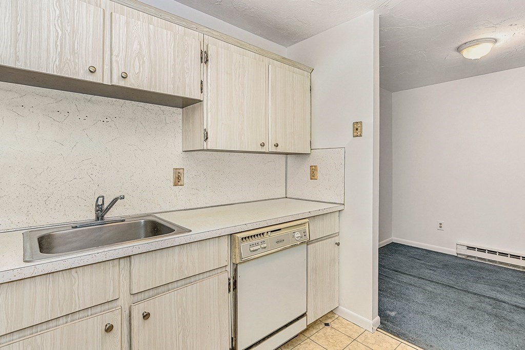 53 Will Drive, Unit 140 Canton, MA 02021 - Photo 10 of 22 a kitchen with white cabinets and sink