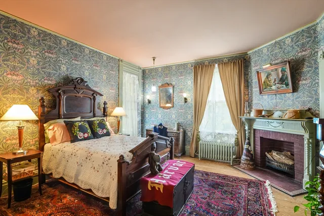 a spacious bedroom with a bed and a fireplace