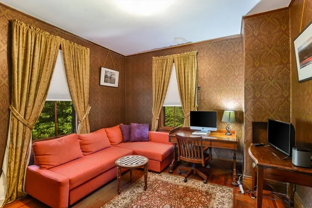 a reading room with furniture and a flat screen tv