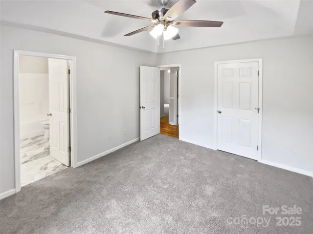 a view of an empty room and a ceiling fan