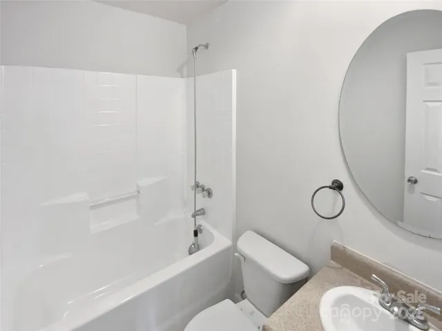 a bathroom with a toilet and a bath tub