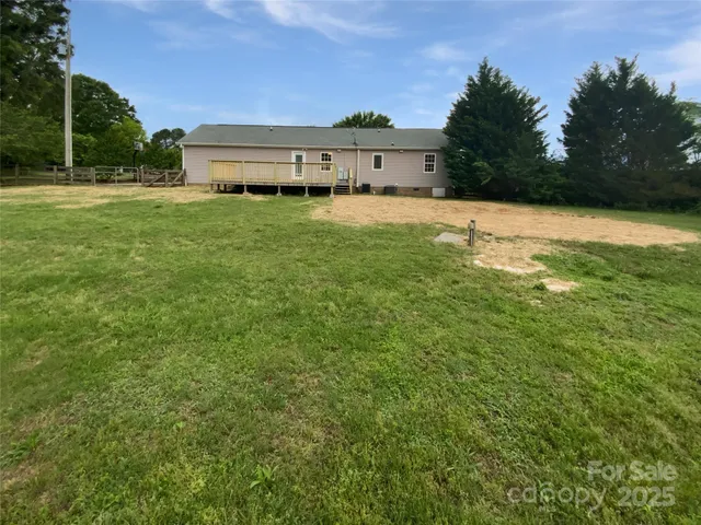 a view of a house with a yard and sitting area