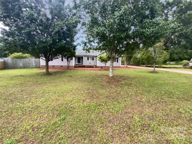 a house with trees in the background