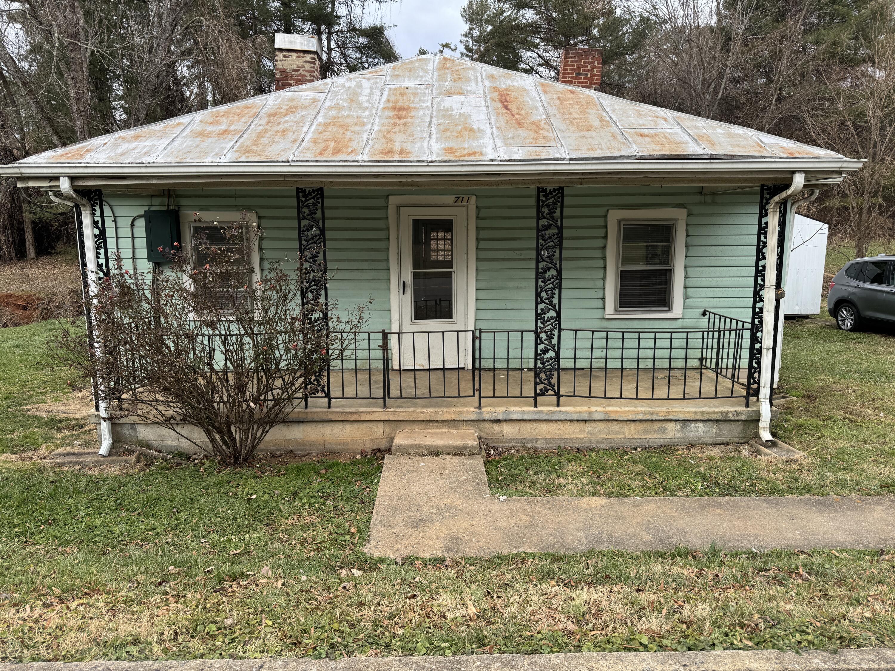 711 Barrows Mill Road Martinsville, VA 24112 - Photo 1 of 10 a front view of a house with garden