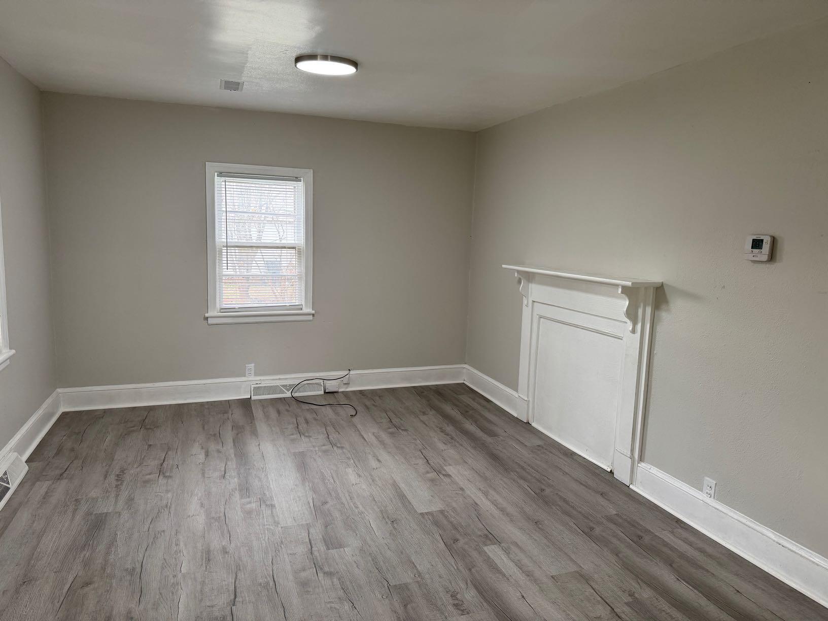 711 Barrows Mill Road Martinsville, VA 24112 - Photo 6 of 10 an empty room with wooden floor and window