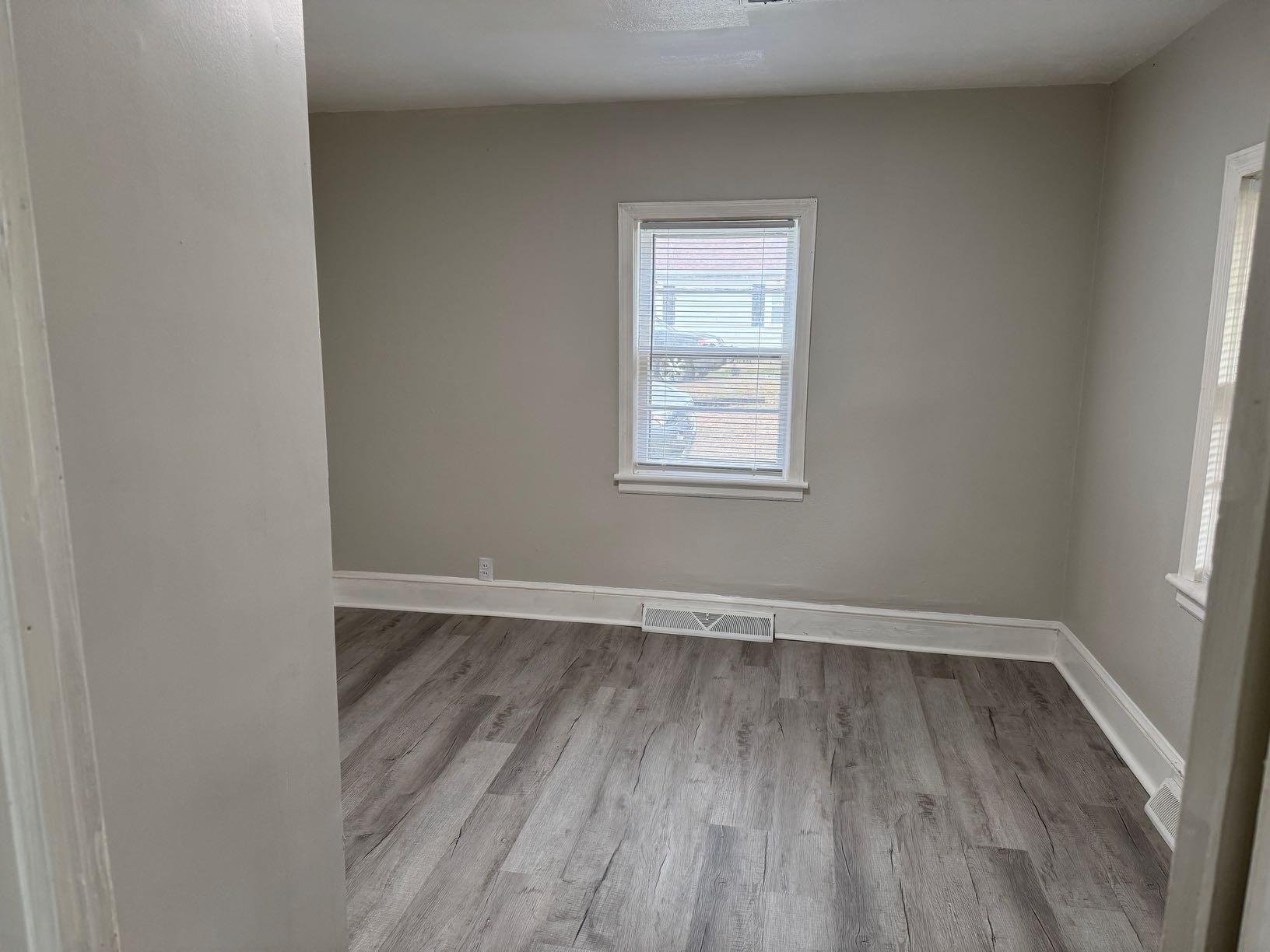 711 Barrows Mill Road Martinsville, VA 24112 - Photo 10 of 10 an empty room with wooden floor and windows