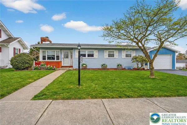 a front view of house with yard and green space