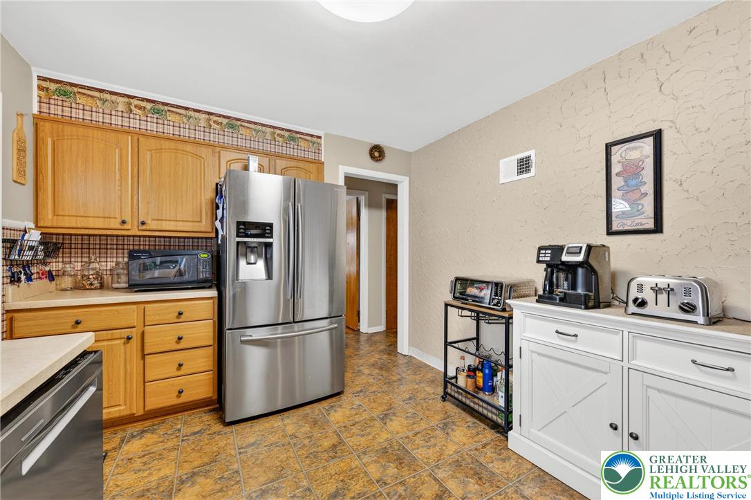 534 Seem Street Emmaus, PA 18049 - Photo 16 of 42 a kitchen with granite countertop a refrigerator and a stove top oven
