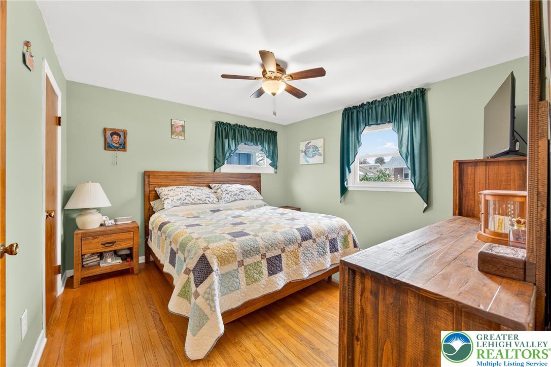 534 Seem Street Emmaus, PA 18049 - Photo 17 of 42 a bed room with a bed and a chandelier