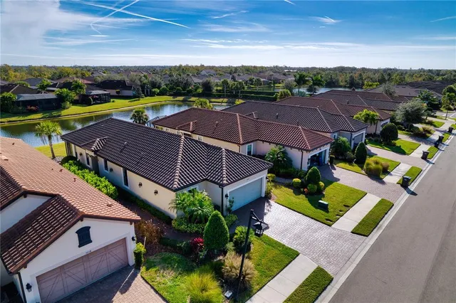an aerial view of multiple houses with yard
