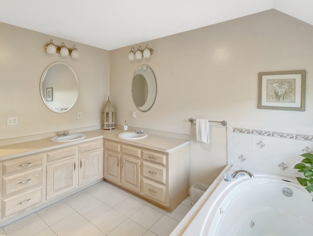 1620 West Street Wrentham, MA 02093 - Photo 19 of 42 a spacious bathroom with a granite countertop sink mirror and bathtub