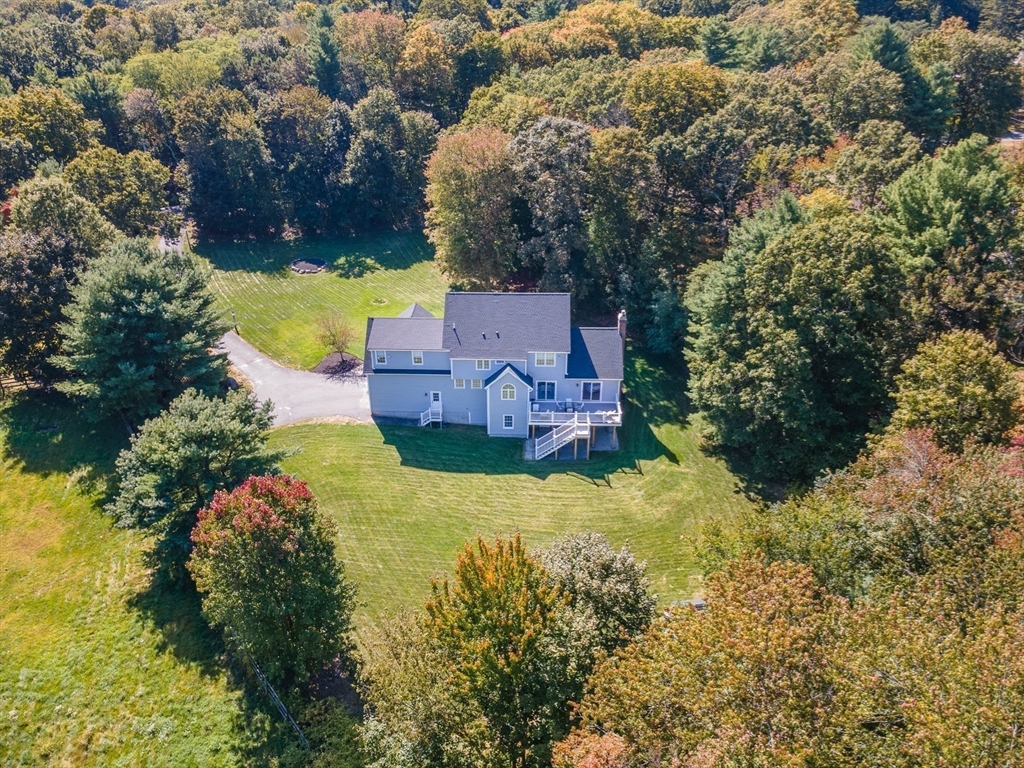 1620 West Street Wrentham, MA 02093 - Photo 40 of 42 an aerial view of a house with a yard and lake view