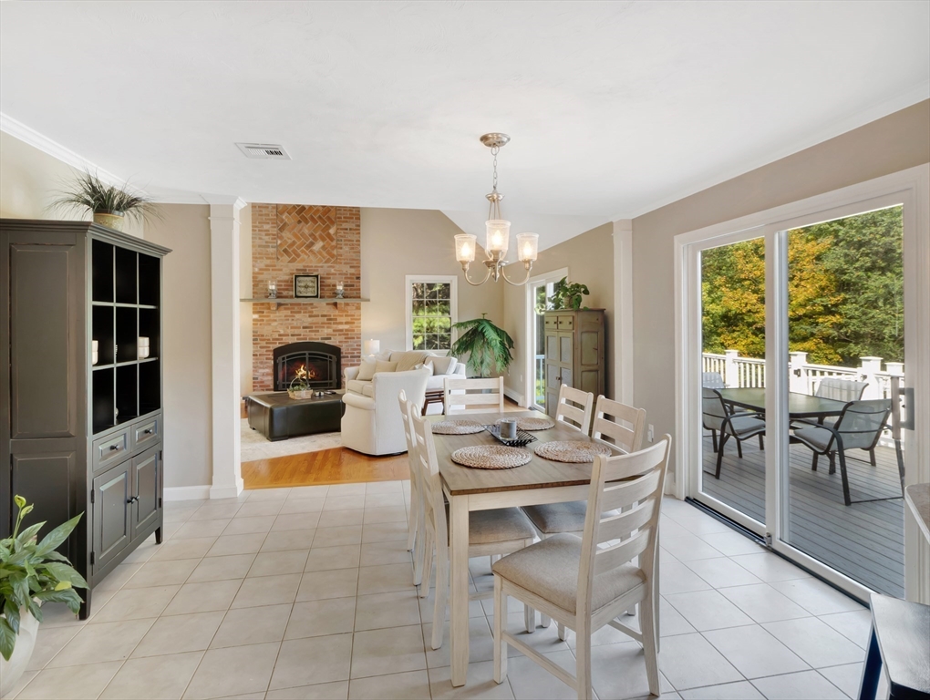 1620 West Street Wrentham, MA 02093 - Photo 6 of 42 a dining room with furniture a fireplace and large windows