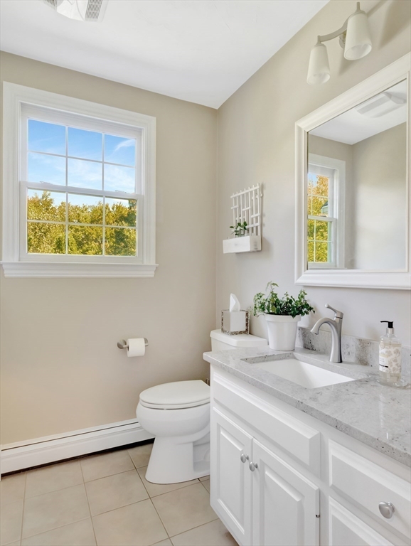 1620 West Street Wrentham, MA 02093 - Photo 7 of 42 a bathroom with a granite countertop toilet sink and mirror