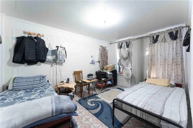 a bedroom with a bed and a chair