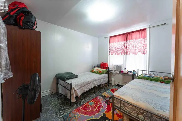 a bedroom with two beds and a dresser