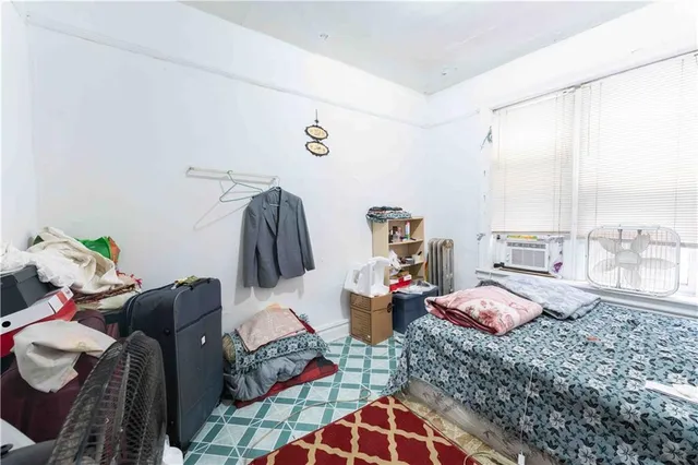 a bedroom with furniture and a window