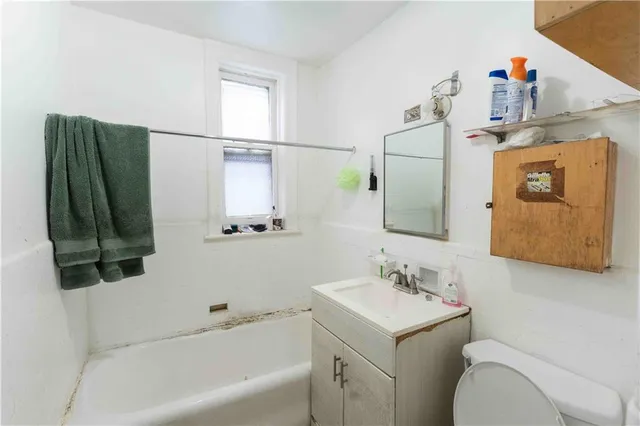 a bathroom with a sink toilet and tub