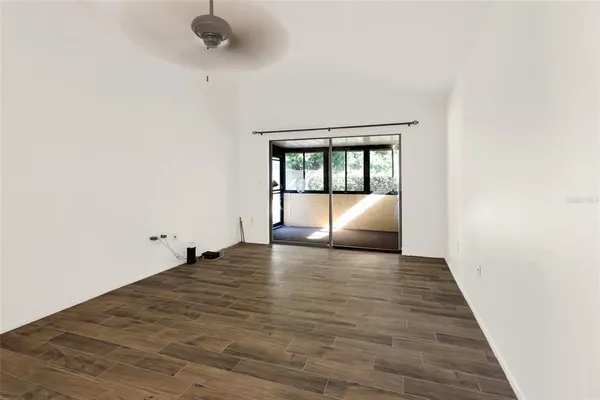a view of empty room with a window and fireplace