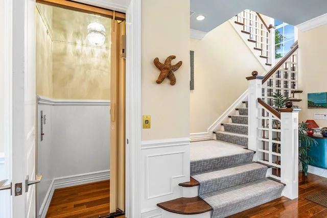 a living room with furniture wooden floor and a flat screen tv