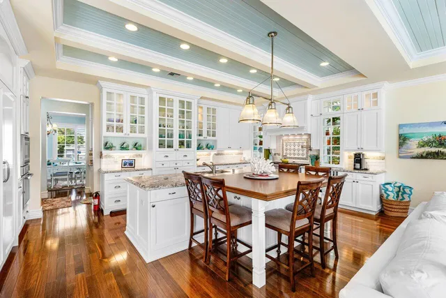 a view of a dining room with furniture a chandelier and wooden floor