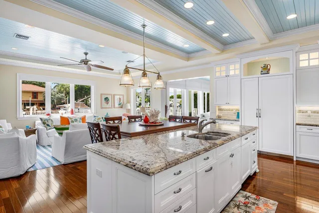 a view of a dining room with furniture a chandelier and wooden floor