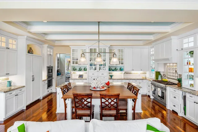 a bathroom with a granite countertop sink a toilet a mirror and shower