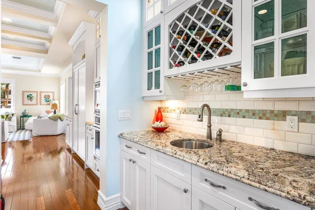 a spacious bathroom with a granite countertop double vanity and a mirror