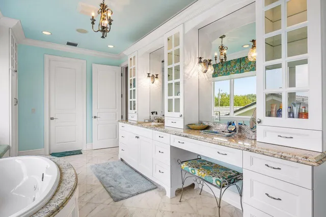 a bathroom with a granite countertop sink a toilet a mirror and shower