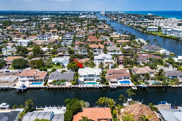 an aerial view of a house with a garden space and a lake view