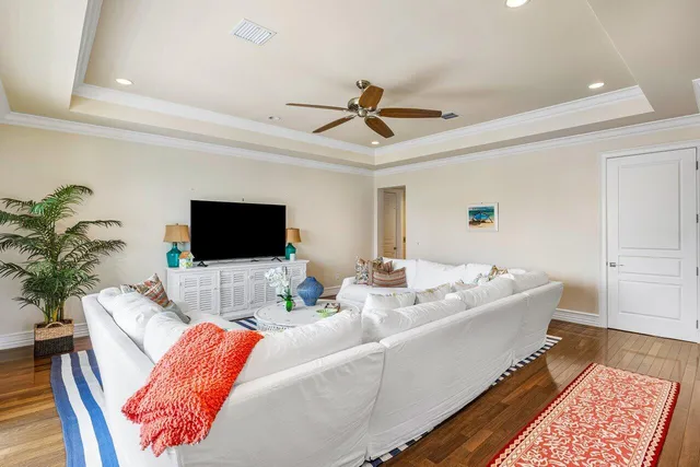 a view of swimming pool with a yard and palm trees