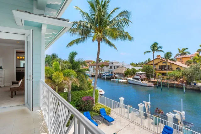 an aerial view of residential houses with outdoor space and lake view