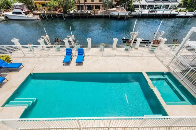 an aerial view of residential houses with outdoor space and lake view