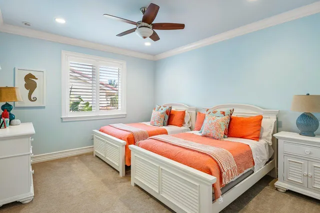 a house with a flower garden and potted plants