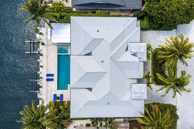 a view of a swimming pool with chairs in patio