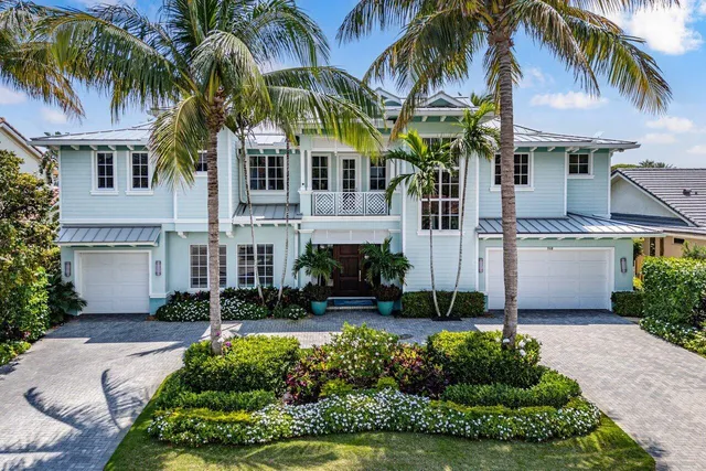 a living room with stainless steel appliances furniture a rug kitchen view and a wooden floor