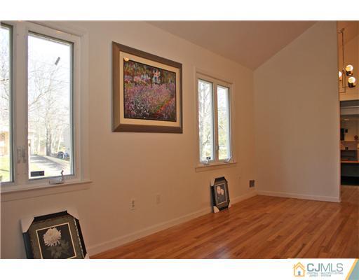 19 Timber Road Edison, NJ 08820 - Photo 16 of 25 a view of an empty room with wooden floor and a window
