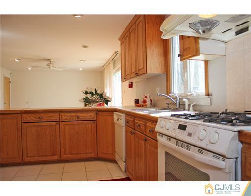 19 Timber Road Edison, NJ 08820 - Photo 18 of 25 a kitchen with stainless steel appliances granite countertop a sink stove and cabinets