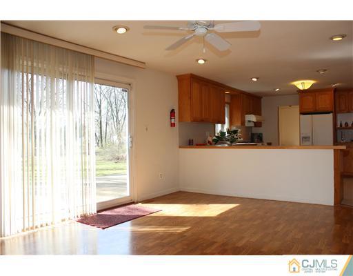 19 Timber Road Edison, NJ 08820 - Photo 22 of 25 a open kitchen with stainless steel appliances granite countertop a refrigerator a sink and a dishwasher with wooden floor
